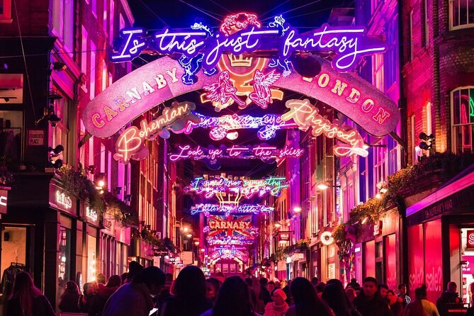 The Carnaby Street Christmas arch lit in pink and blue neon above the shopfronts