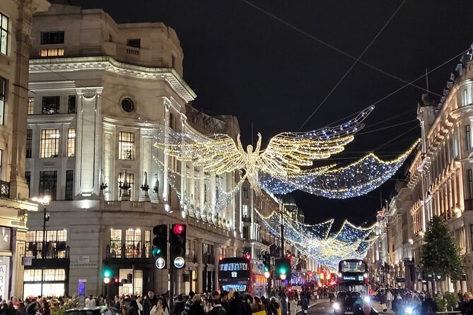 The Spirit of Christmas angels strung the length of Regent Street at night, buses and taxis passing beneath them