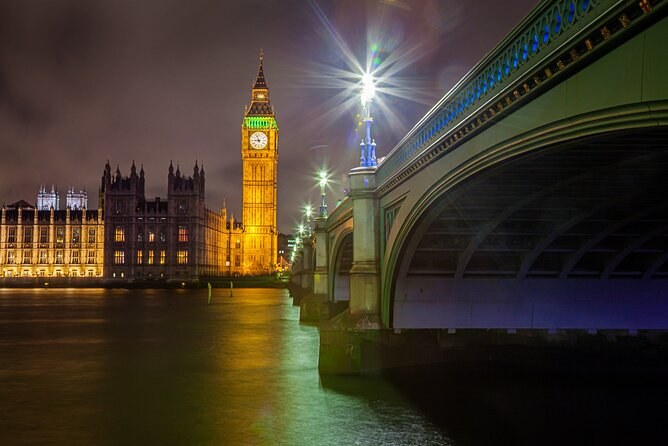 Westminster Bridge lit along its span at night, with Big Ben and the Houses of Parliament behind it